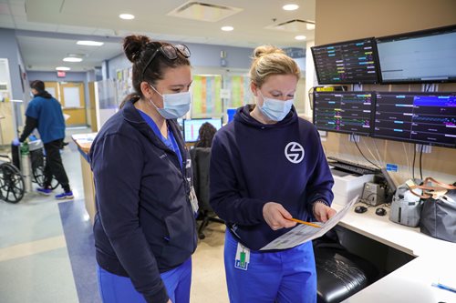 Capt. Samantha DiBlasi, left, a registered nurse working with the Air Force medical team at Lawrence General Hospital, discusses the team’s schedule with Kate Maguire, an Emergency Center charge nurse. (U.S. Army photo by Spc. Daniel Thompson) Capt. Samantha DiBlasi, left, a registered nurse working with the Air Force medical team at Lawrence General Hospital, discusses the team’s schedule with Kate Maguire, an Emergency Center charge nurse. (U.S. Army photo by Spc. Daniel Thompson)